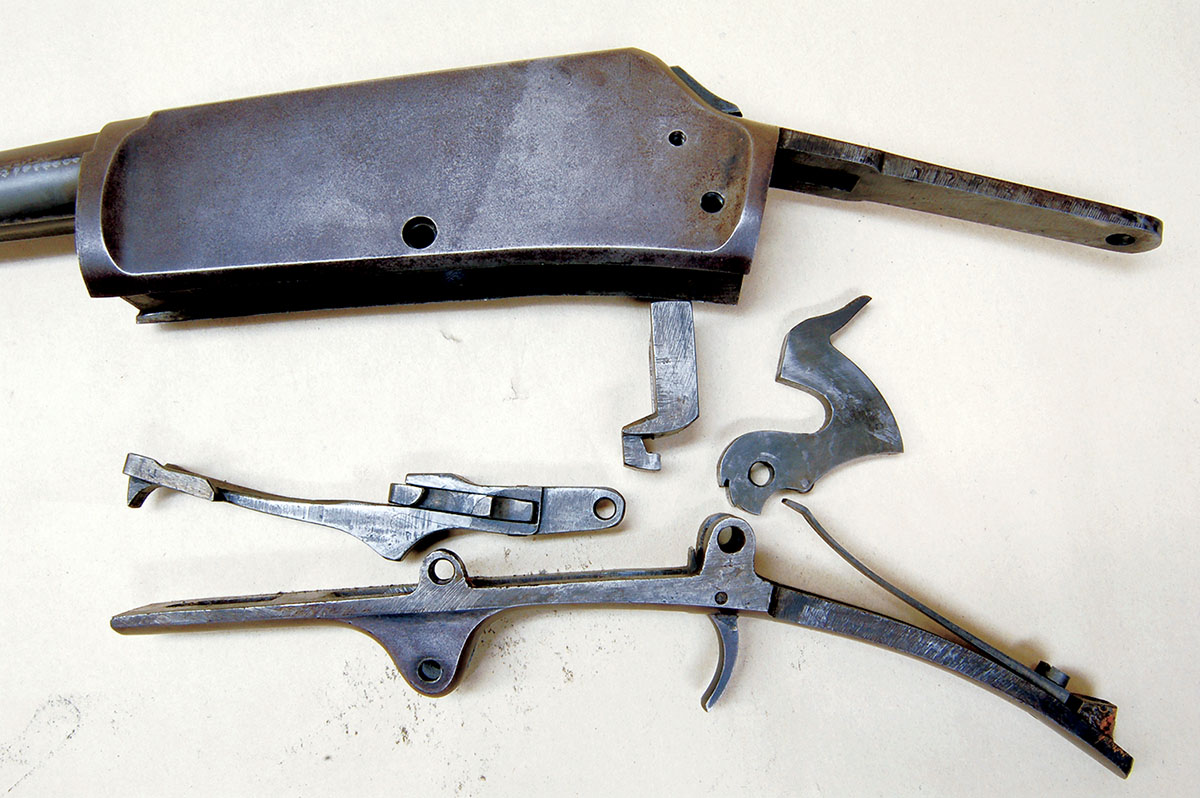 Remove the rest of the receiver screws (except the one behind the loading port), and the rest of the parts drop out. There are no small parts or springs, just big pieces of steel.